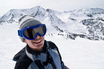 Fototapeta na wymiar Smiling male skier with the Rockies in the background