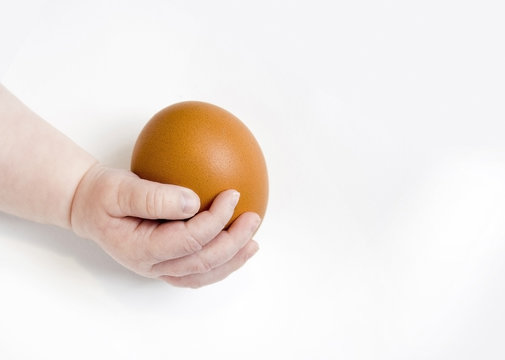Baby holding egg