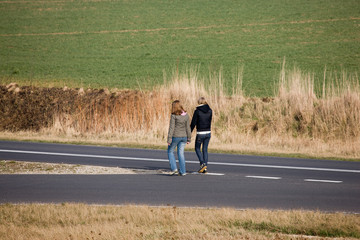 Two teenagegirls going down the road