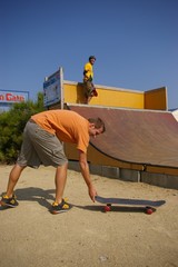 2 skaters at rest on a mini ramp