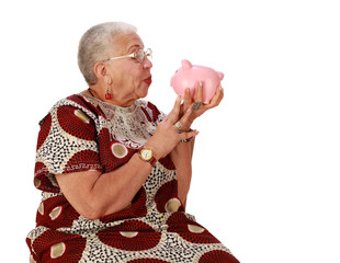 Retired woman holkding piggy bank