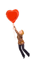 Plakat concept - a girl is flying on a heart-shaped baloon