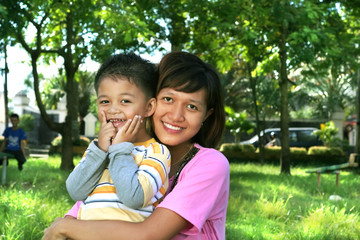 asian mother and son at garden or play ground