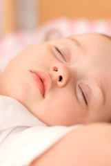 Fototapeta na wymiar sweet baby sleeping on a blanket closeup