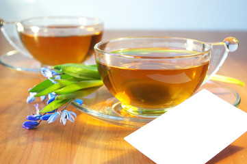 Two cups of tea and flowers