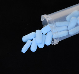 blue pills in a plastic dispenser