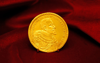 Gold coin on dark red