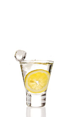 Lemon splashing into martini glass
