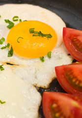 Egg sunny side up frying in a pan