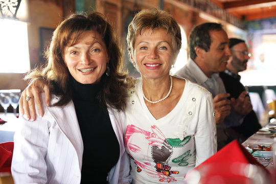 Two Happy Mature Women At Party In Restaurant