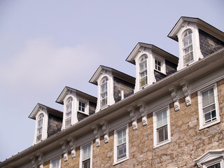 rooftop windows on an old stone building