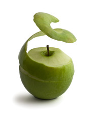 green peeled apple. peel levitates showing pulp