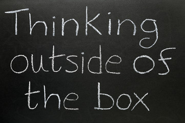 Thinking outside of the box written on a blackboard.