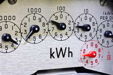 Electric meter dials close-up. Concept meter reading, energy, cost of living, price rise, higher bills.