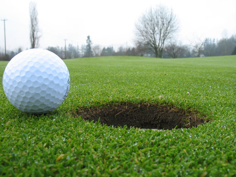 golf ball beside hole