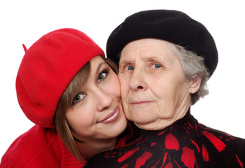 happy grandmother and granddaughter with berets