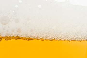 Background from fresh foamy beer.