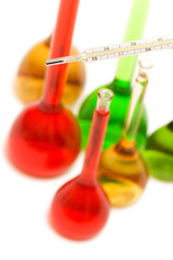 Hand holding thermometer and tubes at the background