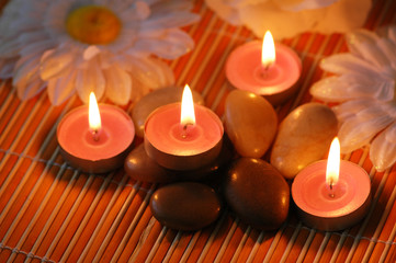 Obraz na płótnie Canvas Aromatic candles and pebbles for spa session