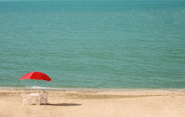 Table with parasols at the summer beach
