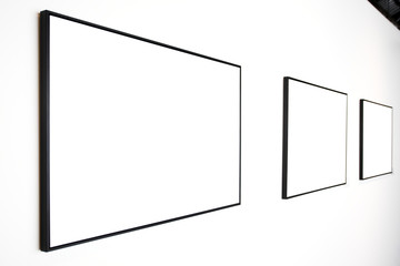 Three  empty frames on white wall