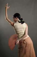 Fototapeta premium hispanic flamenco dancer in traditional pose with fan