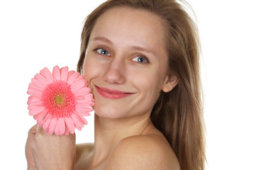Pretty blond with a smile holding a pink gerber daisy 