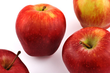 Four red apples on white background