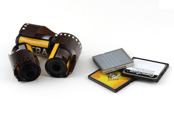 Vintage 35mm film and modern memory cards on a white background
