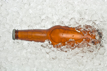 Bottle of beer in cracked ice