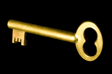 Golden key isolated on black background