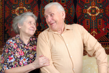 Seventy year old couple smiling at home