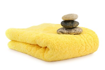 Fototapeta na wymiar Spa stones on a folded yellow towel