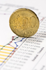 euro twenty cent coin on financial data papers