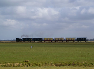 A passenger train powered by a steam locomotive