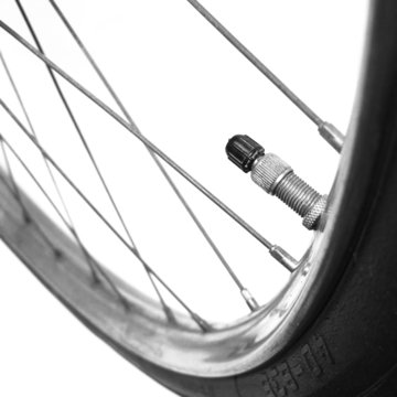 Old bicycle front wheel detail with tyre valve