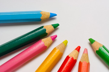 Closeup of some color pencils on a piece of white paper