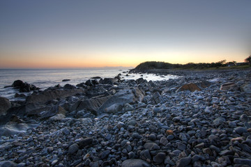 Summer sunrise of a pebble beach