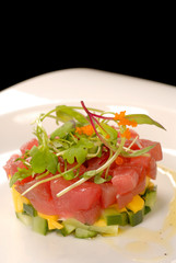 Fresh Asian tuna and mango tartare with micro green salad