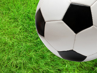 football soccer ball over green grass