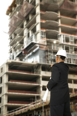 Designer Pointing At Building Under Construction