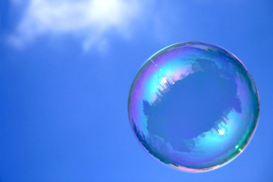 Soap bubble on blue sky