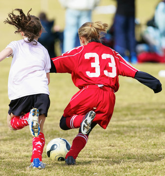 Two Youth Girls Fight For The Soccer Ball During A Game