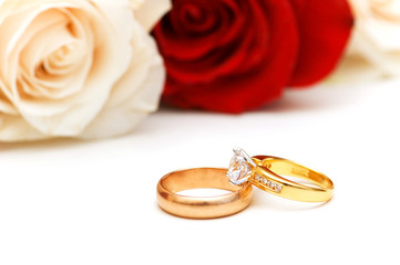 Rose and wedding rings isolated on the white