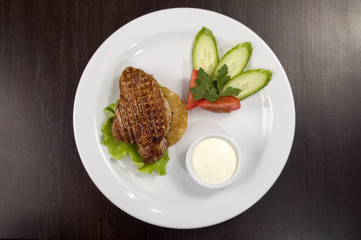 Piece of fried meat with vegetables.