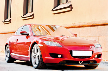 red car on a city street