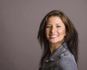 Fototapeta premium Brunette in Denim Flipping Hair