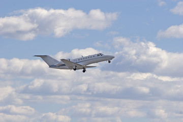 Fototapeta na wymiar White Plane in the Clouds