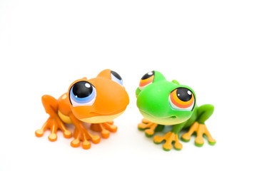Two frog toys isolated on white background