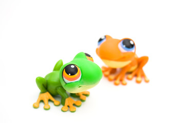 Two frog toys isolated on white background